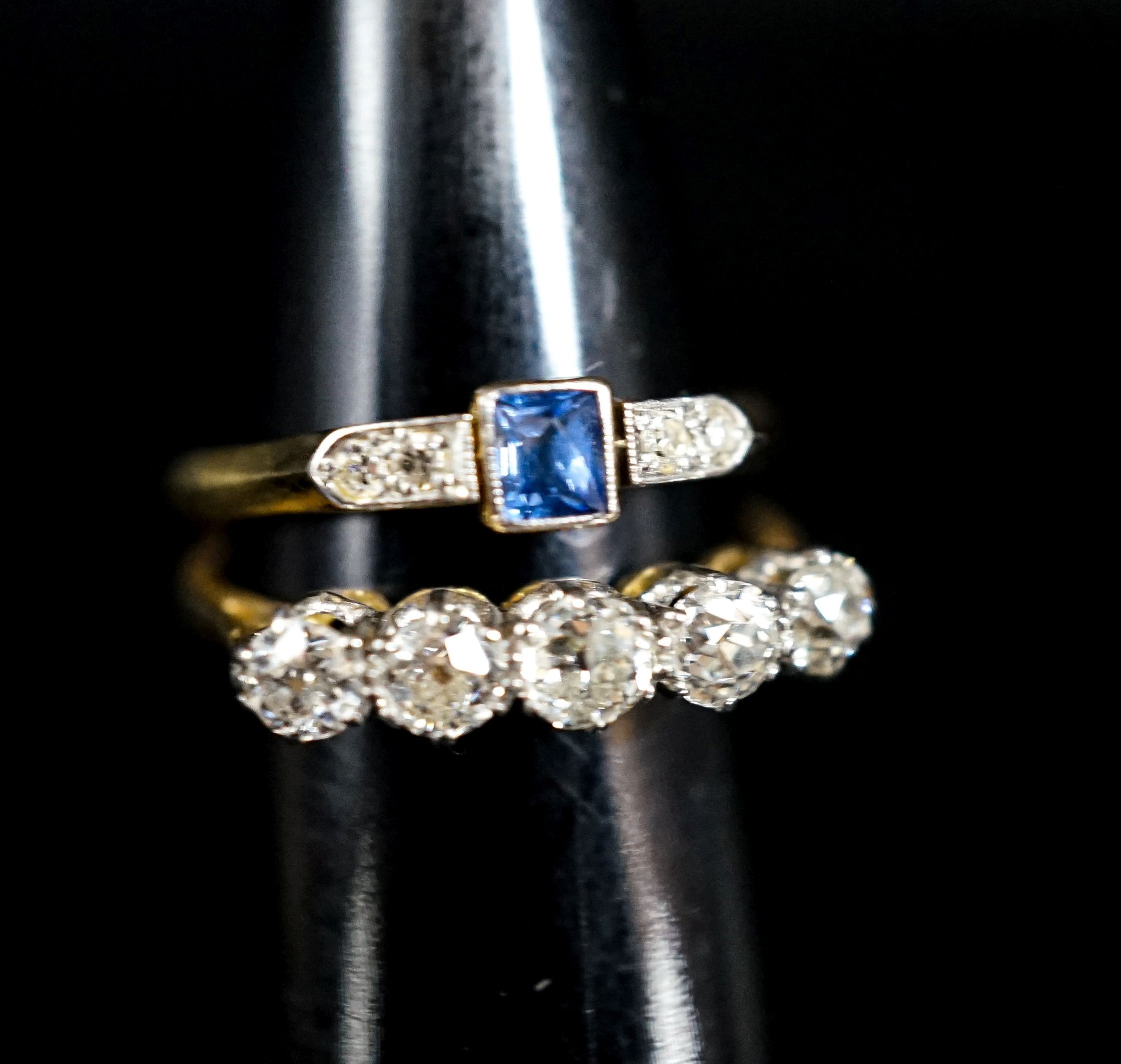 An 18ct and five stone diamond ring and a similar sapphire and diamond ring (now soldered together), gross 4.2 grams.